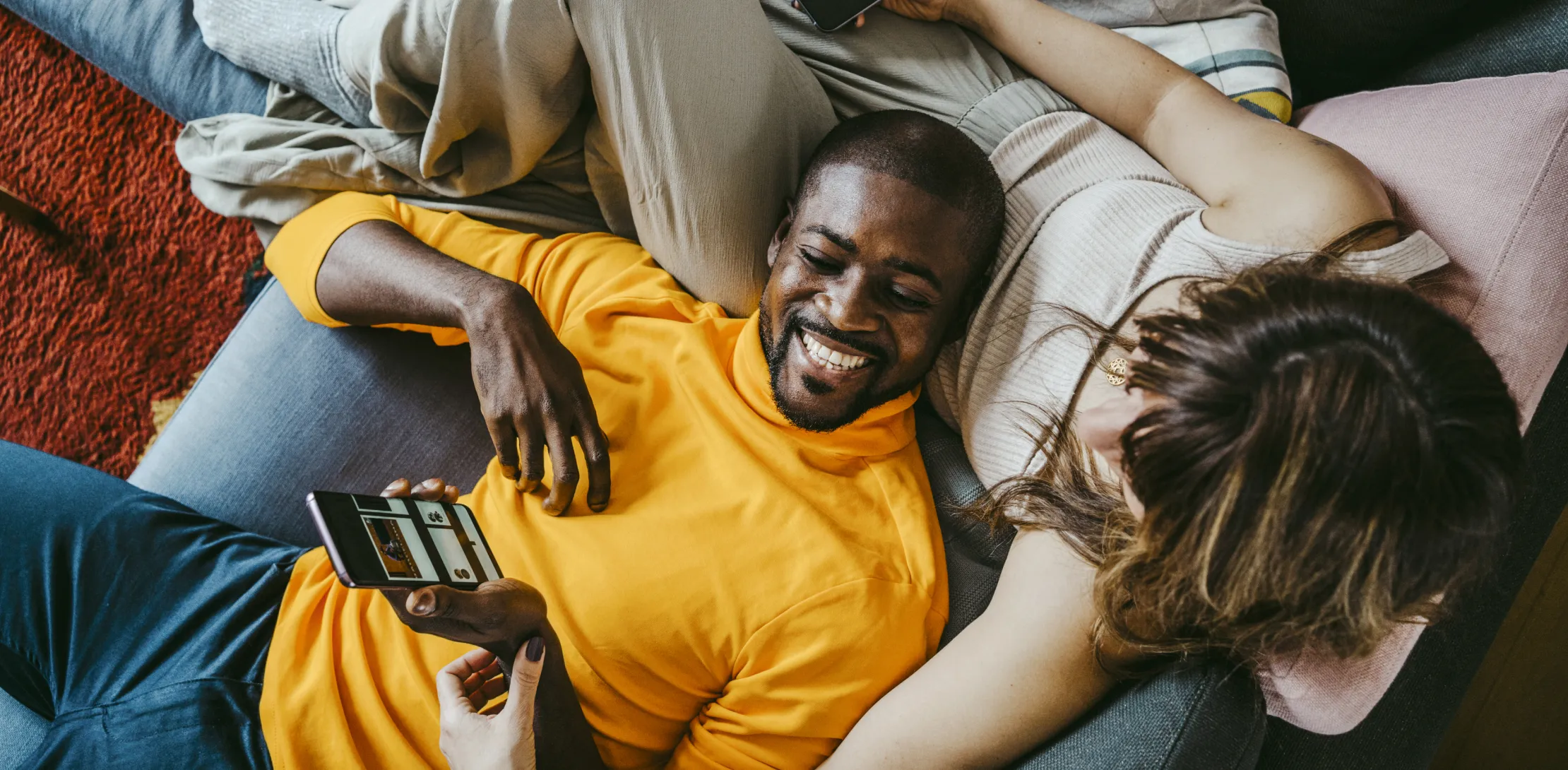 Man and woman on couch with phone